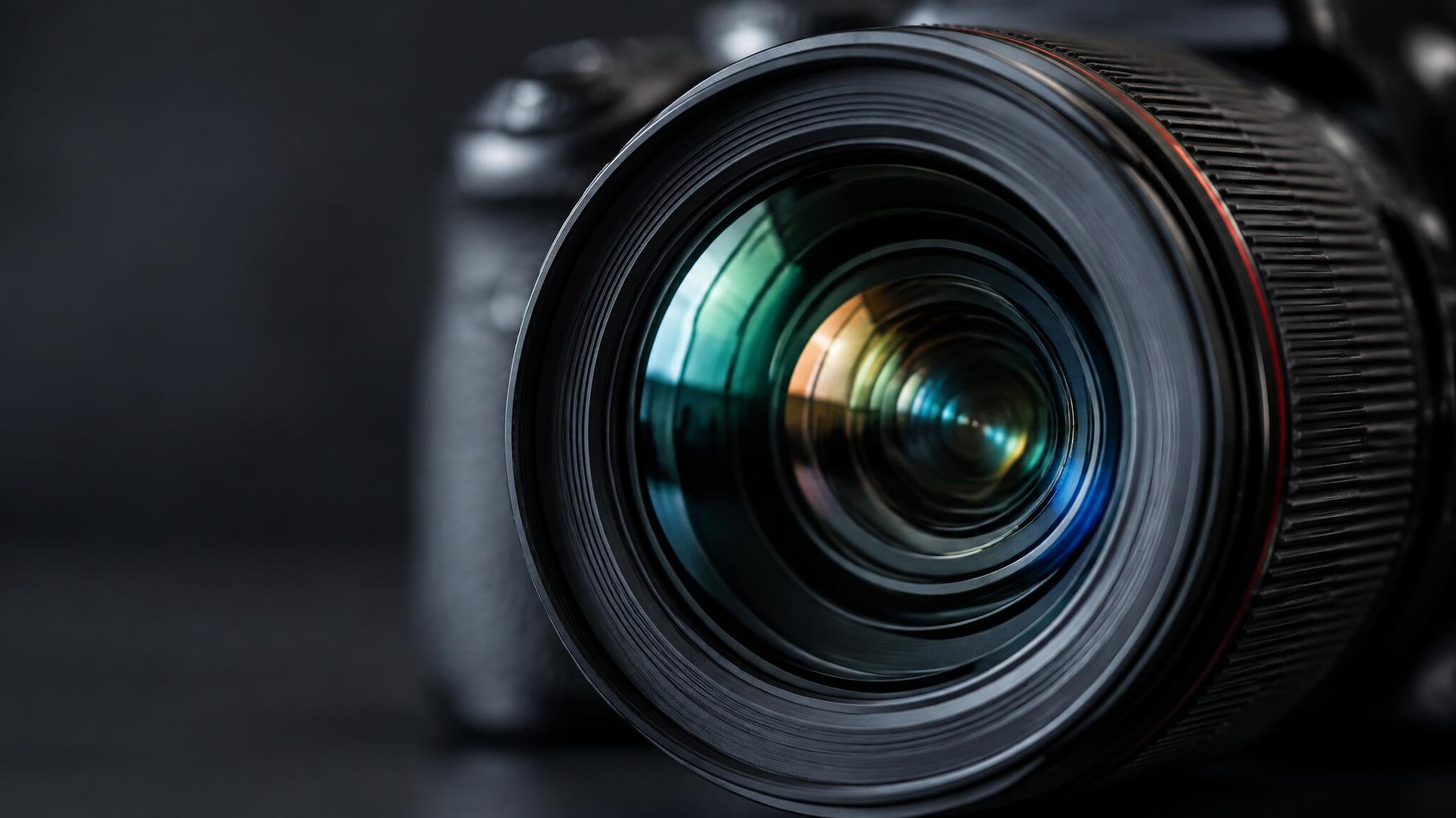 Close-up of a camera lens with a blurred studio background